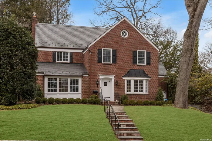 Perfection awaits at this picturesque, classic Munsey Park Colonial. The 4 BR/3.5 BA home boasts original, beautifully maintained arched doorways, original woodwork, gleaming hardwood floors, a guest suite on the main level & loads of additional upgrades and storage space throughout. Gourmet EIK with custom cabinetry, quartz countertops, center marble island w barstool seating and top of the line appliances.The Primary suite has newly custom-fitted closets and an updated marble bath with dual vanity/shower. 2 large bedrooms share a connecting updated marble bath. Full basement with open recreational area, abundance of storage & large laundry room with custom shelving, new washer/dryer. Third floor walk-up attic with hardwood floors/tongue-and-groove paneling between open rafters. Serene, flat rear property with new landscaping. Captivating & comfortable in every way, this exceptional home offers a perfect fusion of vintage charm and modern living.