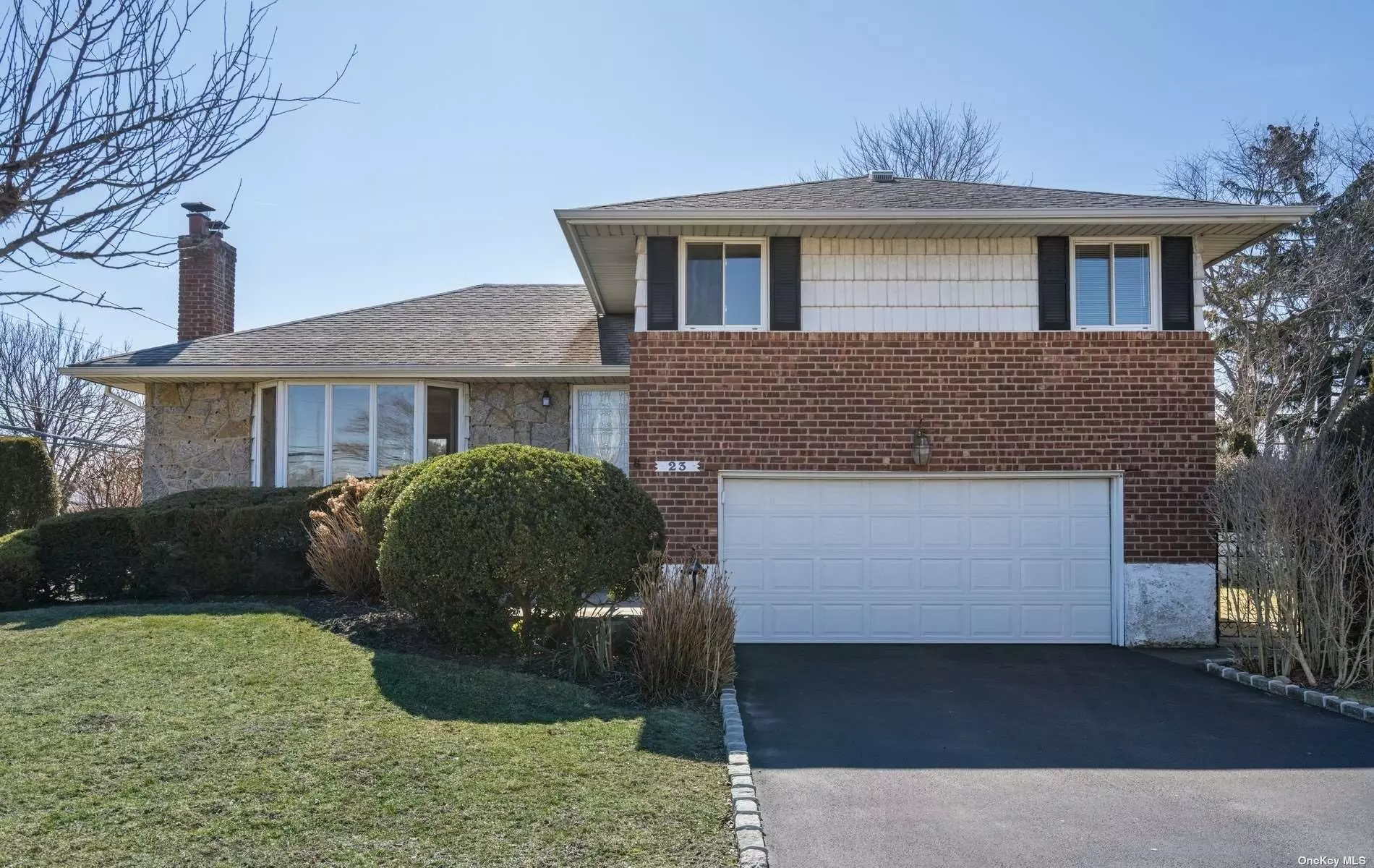 Ready to move in this solid brick split house in Syosset. The house has a finished basement with office and full bath as well as a family room with an outside entrance. There is a bright and inviting living room with bay window and stone fireplace. The recently updated kitchen includes new cabinets, quartz countertop, and stainless steel appliances. Enjoy the newly updated en suite primary bathroom. The house is in a quiet location yet close to great shops and destinations!