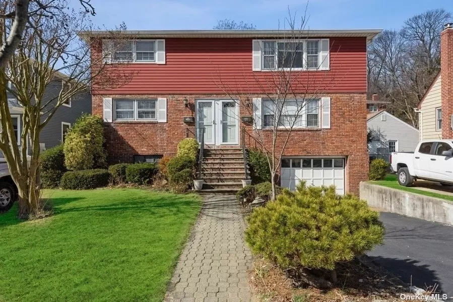 First floor owner is occupied, Second floor is vacant. This very spacious 2-family duplex has 3 bedrooms over 3 bedrooms, Each unit has a very large LR and EIK, and Fbath. First floor 3rd BR used as DR, and screened Porch off the EIK leads to rear yard. Hardwood floors in both apartments. Full basement partially finished with fireplace, has out side entry to yard plus door to 1.5 car garage. Single oil burner with separate zones for each unit can easily be adapted to 2 burners. Washer & Dryer and New Oil Tank in basement. Generous parking with three curb cuts off the street, two for individual parking spots, third to driveway garage.