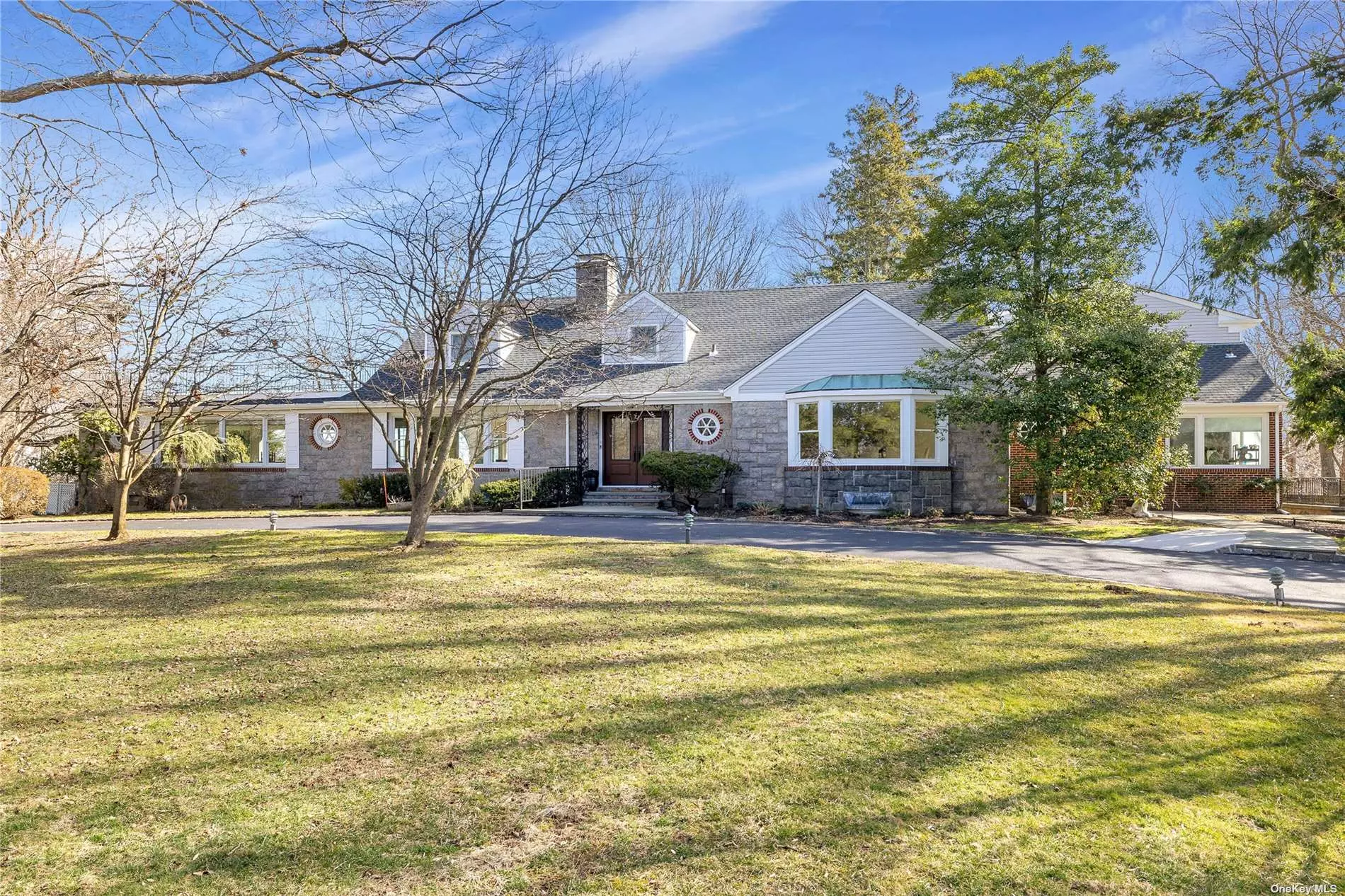 No detail overlooked in this newly recently & expansive 6 bedroom 6.5 bath colonial in Harbor Acres of Sands Point once the location of William Bourke Cockran Congressman and largest landowner in Sands Point built his mansion estate taking advantage of panoramic water-views.  Perfectly tucked away on the end of a cul-de-sac and perched up with a very regal presence is situated on 2.7 acres.  You are greeted with a circular driveway that leads you to a double door entrance. Open the doors and let the walls of glass windows draw you to the most spectacular water-views from every window.  Open Concept Living at its best with brand new sleek & stylish kitchen w/large quartz center island, custom cabinetry and high-end appliances that opens to both the family room and formal living room w/wood burning fireplace. A home made for entertaining with a great room that has a custom wetbar, formal dining room with serene views of the landscaping. Taxes Successfully Grieved.