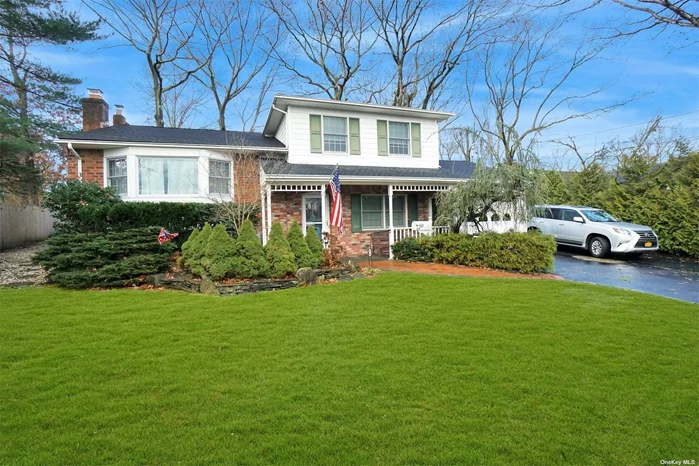 This expanded Split in Oyster Bay offers an oversized property with a yard great for gatherings on the multi-level deck and a private driveway for 5+ cars. This home offers spacious interior square footage from the tri level expansion. The main lever has a semi-open floor plan for the living room, dining room and kitchen areas and you will also find a beautiful spacious den with custom built-ins, a second fireplace, high ceilings and lots of windows to bring the outdoors in. There are 4 bedrooms, 2 full baths and a finished lower level with a cozy den and an amazing recreation room with a wet bar. Close to schools, shopping, beach and more. This is a must see house!