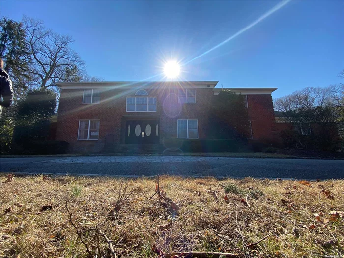 This amazing 6600 sf, sprawling, 6 Bedroom, 5.5 Bath brick Colonial on 2 flat acres is located in the highly desired Oyster Bay area and Sherwood Gate Development. The grand entry boasts a classical curved wood staircase with iron balusters and an over 20 foot ceiling. The downstairs area has beautiful wood floors throughout as well as 3 wood burning brick fireplaces. The huge Eat in Kitchen leads into the also generously sized Formal Dining Room through the Butlers Pantry. The 4 car garage and full basement have unlimited potential. Sliders at the back of the house lead to an outdoor deck with an outdoor kitchen and entertaining area. The stone and slate custom designed inground gunite pool makes for resort style backyard potential. Another amenity to add to the list is an Olympic sized tennis court with high end lighting for an optimal night time match. With some updating and personalization this property is a Dream coming to Reality.