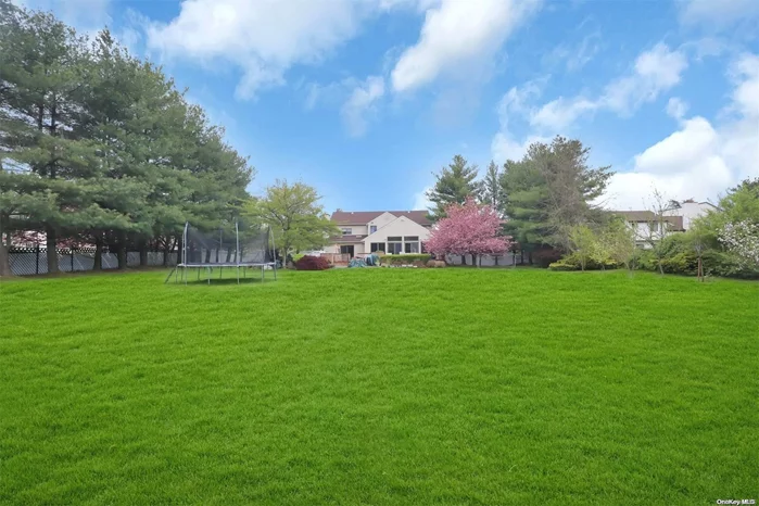 Fabulous 3782 square foot home in Woodbury set on 1 beautiful, flat usable acre. Spacious floor plan with extended great room off the kitchen; soaring ceilings, skylights, hi-hats, walls of glass, doors to maintenance free deck,  overlooking parklike property and adjoining to open concept kitchen. Large eat in kitchen has dual level granite countertop opened to great room with SS appliances, breakfast area and mud room conveniently located off garage. There is a formal banquet sized dining room, a second family room with vaulted ceiling, skylights, wood-burning fireplace and doors to rear property. A sunlit formal living room and guest powder room complete the main level. Second level primary bed. has full ensuite bath, cathedral ceiling and closets. Plus additional 4 bedrooms and full bath. The lower level is finished with office, rec room, full bath, utilities and storage. The rear property has specimen plantings, parklike acre and maintenance free deck. Gas heat &water filtration