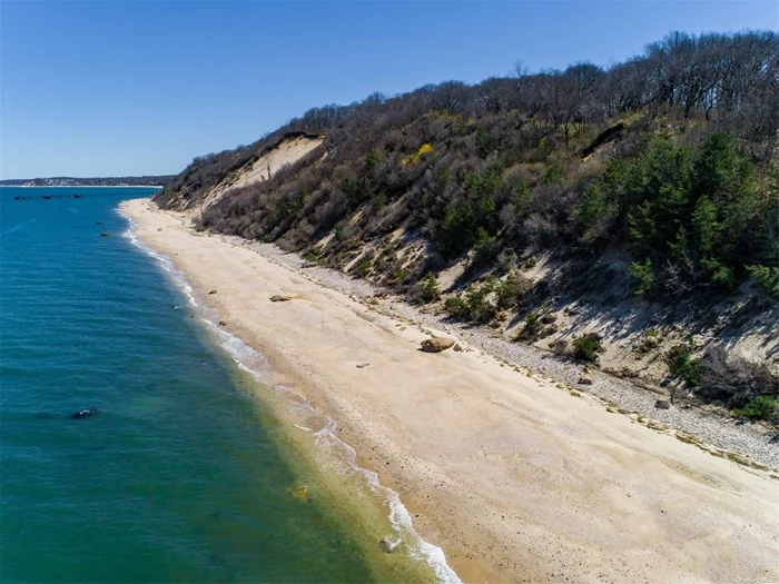 Set high upon a bluff on more than 3.4 acres, a magnificent sound front property with a right-of way to 167&rsquo; feet of private, sandy beach and an original 3 bed, 2 bath ranch.  Amazing homesite with infinite possibilities. Restore the existing home or invest in additional site clearing to accommodate a large beach house with views across to Connecticut. This property is situated in a one-acre RA40 Zone making a subdivision possible.   Property next door is also available with 2.26 additional acres. (Also offered as Land Only at MLS #3390409).