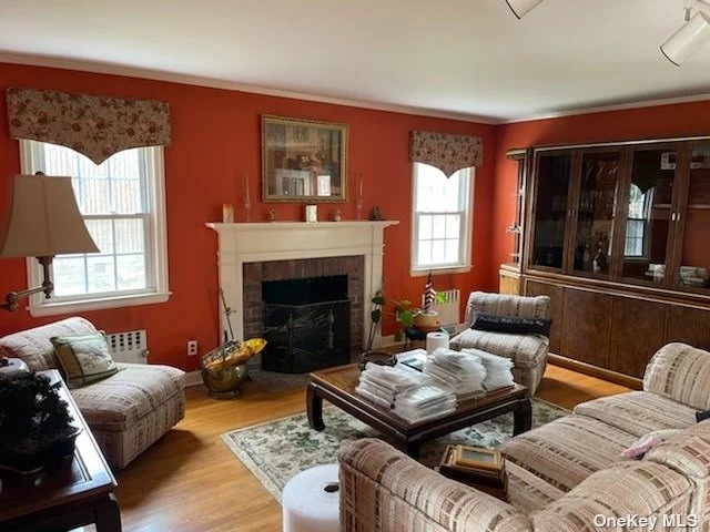 Sunny Detached Colonial features Main Level- LR w/fplc, FDR, KIT. Second Level- 2 Bdrms, 1 Full Bath. Finished Bsmt w/Family Room, 1/2 Bath, Access to 1 Car Garage & Private Driveway. Attic for Storage. Large Private Lot Size! Very Convenient to Transportation (LIRR), Buses & Shopping.