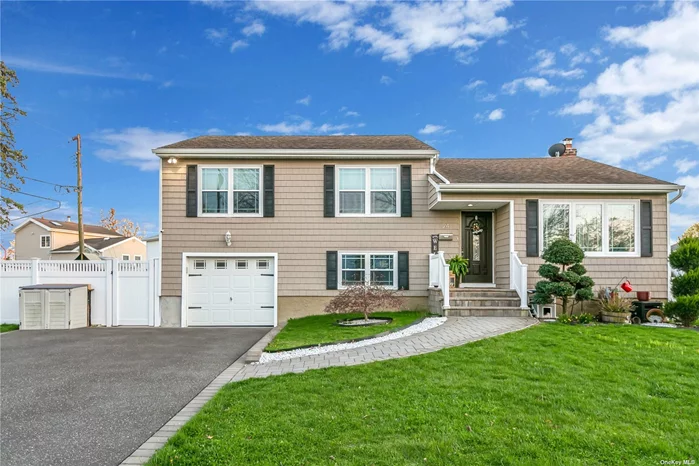 This stunning single family Split Level home in highly desirable Farmingdale. Boast a private entrance,  thoughtfully landscaped grounds on a sprawling corner lot. Upon entrance, you are warmly greeted by wood floors, a bright and open floor plan seamlessly connecting the updated kitchen adjoining the living room and dining room leading to the inviting, sunny backyard deck. Meticulous attention to detail is presented in the kitchen with granite countertops, smart security system, heating, and sprinkler systems. Third floor master bedroom with full bathroom, two additional bedrooms with full bath. The main level has a comfortable family room, full bath and private entrance. The attached garage showcases an amazing work station with shelves and storage. The basement has an additional family room, and updated washer and dryer offering additional flexibility. The backyard showcases a gorgeous fenced yard, deck, patio, and even a putting green. This house is a dream come true.