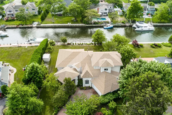 Enter This Custom Built 2001 Waterfront European Style Home In Boaters Paradise with 110&rsquo; of Bulkheading, Boat Lift, And Easy Access To Ocean. The Large Cobblestone Driveway Lined With Fruit Trees Is Just The Beginning. Upon Entering The Elegant Foyer, Your Eyes Are Drawn To The Custom Artisan Wood Floors Featuring Detailed Design Exported From The Top Euorpean Manufacturer, In Addition To The Coffered Ceilings And Solid Wood Doors. Simply Turn On The Gas Fireplace To Warm The Spacious Main Floor Living Area, Including Open Concept Kitchen With Stainless Steel Appliances And Granite And Marble Countertops. Need To Unwind? Relax In Your Own Steam Room/ Sauna Located In The Main Floor Primary En-suite Bedroom Featuring A Gas Fireplace, Followed By Some Much Needed Spa Time In The Private Outdoor Jacuzzi. Family And Guests Will Surely Enjoy Separate Second Level Bedrooms With A Full Bath, Jacuzzi, And Also A Library.