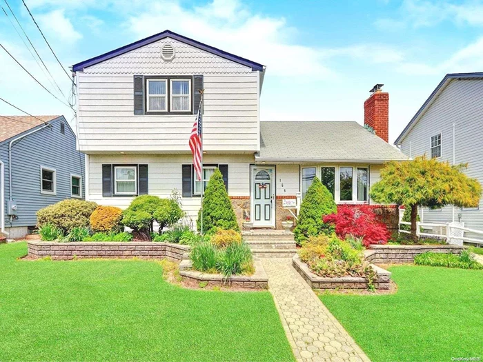 Welcome to this Expanded Mid-Block Home w/Full Bsmt & oversized 1 Car Garage. Walk-In Attic can easily be made into another room! HW Floors, Hi-Hats, IGS. Mud Room by front entrance. First Floor BR/DEN/OFFICE w/Sliders to Deck w/Awning. HUGE MBR/BIG Closet. Fin BSMT w/Bar & Reading Nook. New Washer. 2 Wall AC units. Lovely Landscaped Yard. LIRR nearby. Stove working but Not Represented.