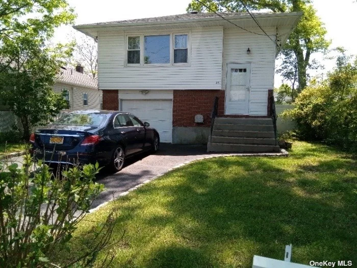 Lovely In line Hi Ranch! Living rm dining area, New kitchen! updated bath, 3 brs upper level. Hardwood floors thru out. Lower level Finished playroom, den/Br or office area, laundry rm, storage area, 1 car gar, full bath. Out side Entrance. Sachem Schools! Close to RR, Buses, shopping. Lots of possibilities.