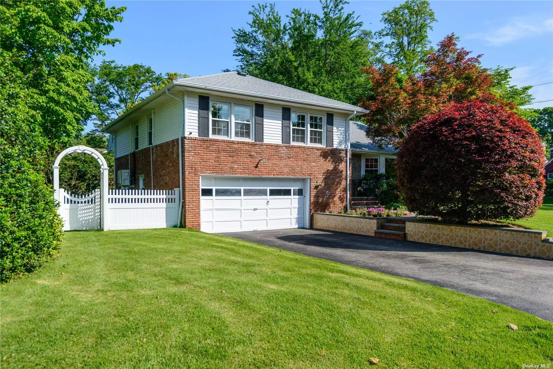 Sun filled 3 bedroom/1.5 bath split on a fabulous oversized corner lot in the Terrace section of Port Washington. Walk into the wonderful living room with grand fireplace that opens to the dining room and updated kitchen with granite countertops and s/s appliances. A fantastic sun room with 2 sky lights completes the first floor. Family room and powder room are on the lower level and a fully finished basement with laundry completes this home. 2 car garage, 3 ductless a/c units, hardwood floors thru out, radiant heat in family room and a new roof in 2021. Convenient to town, train, shops, restaurants and beautiful Manhasset Bay. This house has it all.