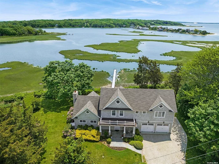 Set on a half acre with 160 feet of waterfront, this custom-built boat-lover&rsquo;s home features a private dock and expansive views of Peconic Bay. Nearly every room in this shingle-style transitional home is showered with aqua blue light from the Bay, while framing beautiful views across to Robin&rsquo;s Island. Floor-to-vaulted-ceiling windows adorn the double-level great room, flanked by the custom kitchen, large pantry and light-filled breakfast/dining room on one side, and the richly-lite family room with fireplace on the other. Access to the garage, laundry room and full bath finish off the ground floor level. The second-level owner&rsquo;s suite, featuring an impressive walk-in closet and luxurious, spa-like bathroom. Two guest bedroom, full bath and office/den finish off this level. The setting and views are unparalleled.