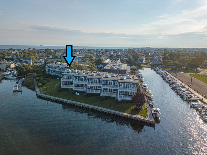This BAYFRONT END UNIT townhome is one of the largest in community w/approx 2, 737 sq ft & offers unobstructed bay &bridge views from 2 composite decks (upper & lower). Unit also has the ELEVATOR w/access to all 3 floors of the home (garage, 1st & 2nd flrs). Enjoy a short trip to Fire Island from your 42&rsquo; DEEDED boat berth. NO flood insurance required in X zone with 8&rsquo; elevation. This designer decorated home has 12&rsquo; ceilings in lv rm, kit & dining area. White EIK w/new stainless app&rsquo;s (induction stov & granite counters, oak flrs throughout, 3 large bdrms all en-suite w/NEW baths. Huge mstr bdrm suite w/WIC & NEW mstr bath, 8-zone radiant heat (inc garage), 2-zone (1st & 2nd Flr) rooftop CAC, central vac, alarm, gas utilities, 2 gas FP&rsquo;s (in MBR & LR), surround sound speakers, 200 amp electric, . French doors to 2 composite decks (liv room & mstr bdrm) w/amazing bay & bridge views. Approx 800 sq ft of add&rsquo;l cement flr finished storage area. The BEST LOCATION in the community!