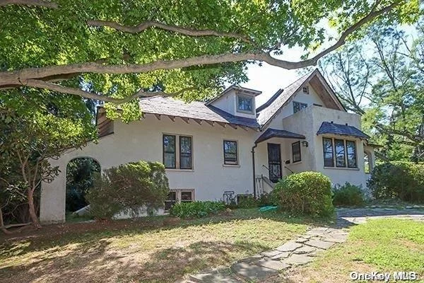 A Hidden Gem! This Beautiful Tudor Style Home is Perched on Over Half an Acre in a Prime Location, Tucked behind Hedges, on a Slightly Elevated Lot. The Home Boasts Three Bedrooms, Including Two on the Main Level, Two Full Bathrooms and an Office. The Living Room Features a Wood Burning Fireplace and Sliding Doors Which Provide Access to a Porch Overlooking the Spacious Private Yard. The Renovated Kitchen Boasts Stainless Steel Appliances, Granite Countertops, Radiant Heated Floors, a Pantry and Door to the Backyard. The Ground Floor Bath Has Radiant Heat, a Jacuzzi Tub and a Separate Shower. The Sundrenched Second Floor Bedroom Features Walls of Windows and a Large Skylight. Hardwood Floors Throughout, Windows Which Allow For Lots of Natural Light, and Upgraded Mechanicals. The Half Above Grade Cellar has an Outside Entrance. Short Distance to Sea Cliff Elementary, Beach, Park, Public Transportation and Downtown. A Must See!