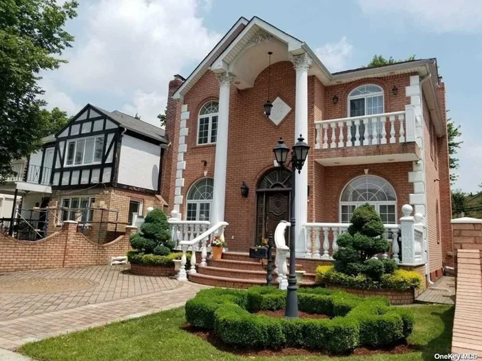 Exquisite Brick Colonial with regal columns, a front terrace, and a paved walkway/driveway sits on a well-manicured property in a desirable Fresh Meadows neighborhood. A spacious foyer with custom closets on each side of the front door welcomes you to this stunning home with gleaming inlaid hardwood floors, exquisite molding, cathedral and coffered ceilings, and spectacular designer details throughout. Entertain guests to the large and inviting living room. Meal preparation is a breeze in the contemporary kitchen complete with plenty of cabinetry, granite countertops, stainless steel appliances, and an eat-at peninsula. Enjoy formal meals in the elegant adjacent dining room with floor-to-ceiling windows and sliding door access to the beautiful patio and gated backyard. A guest suite/ family room and a full, brand new custom bath complete this level. Four sunny bedrooms each have ample closet space, and 2 full bathrooms w/ jet corner tub, completing this floor.