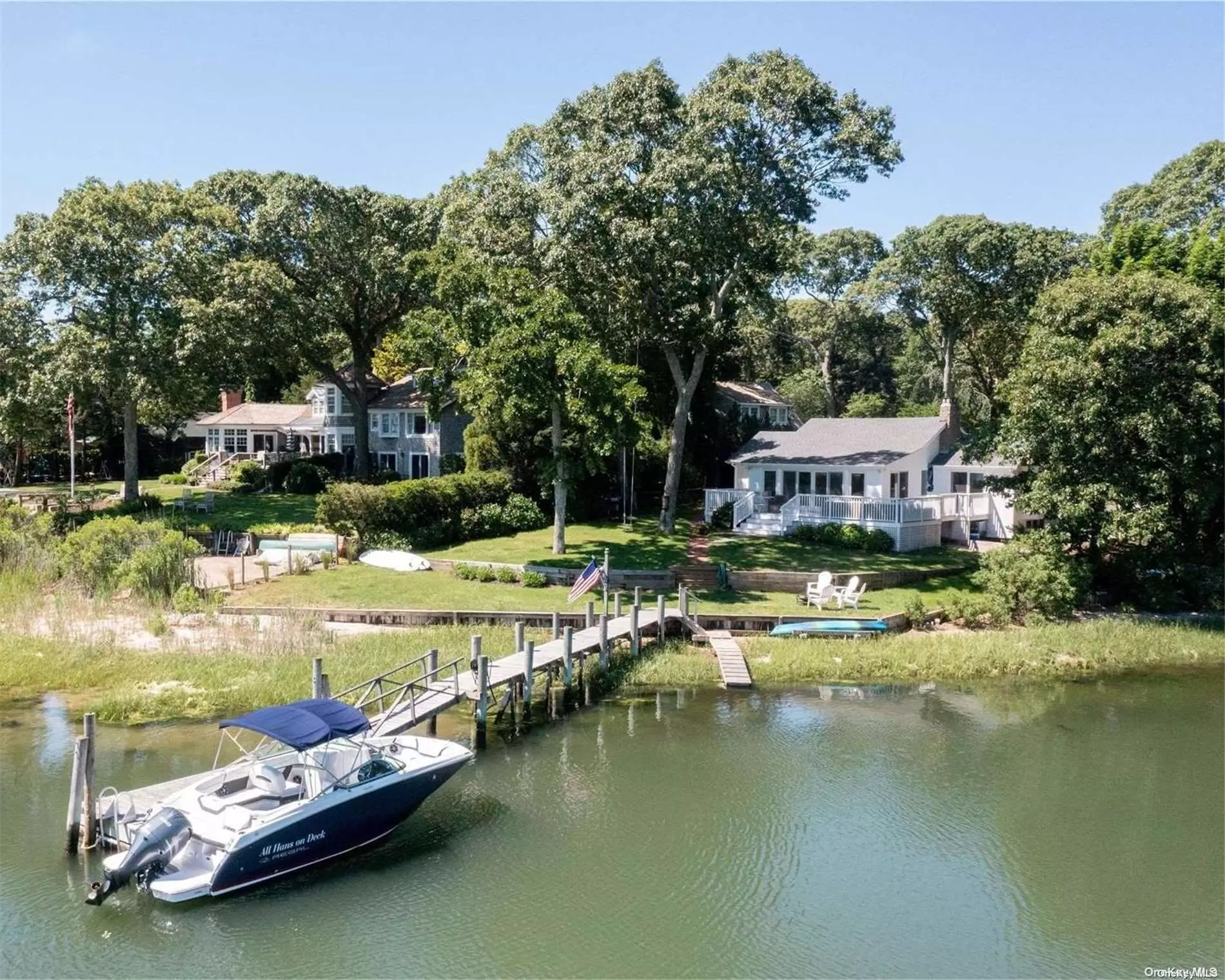 Newly renovated white & bright waterfront with views of the creek and Peconic Bay from every room, and deep-water dock with easy access to the Bay. Custom eat-in kitchen, living room with wood burning stone fireplace, dry-bar, and dining, all in an open floor plan with soaring vaulted ceilings. Large windows face the water with sliding glass doors that lead out to a large deck, equipped with outdoor speakers, perfect for entertaining. Room for pool, outdoor fireplace, and outdoor shower. Close to Nassau Point Causeway Beach, North Fork Vineyards, and farmstands. A chic boaters paradise!