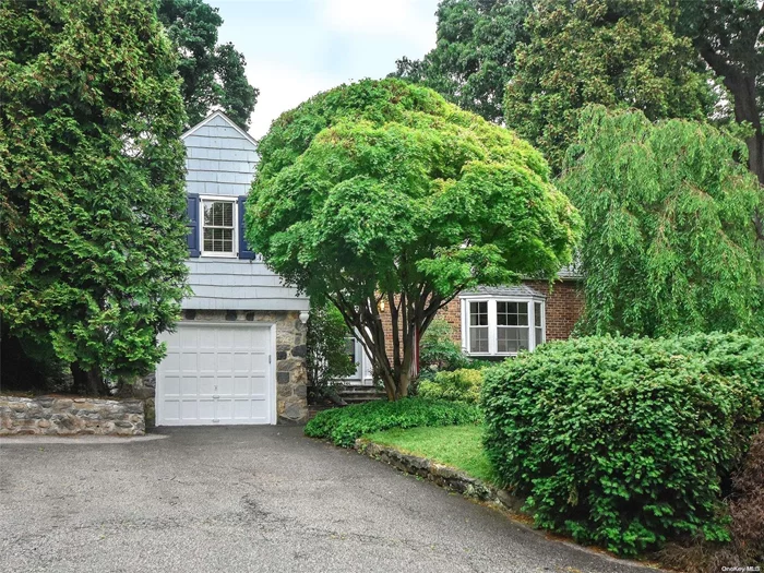 Charming 3, Potential 4 Bedroom Cape in the Coveted MANHASSET BAY ESTATES Section of Port Washington. Original Architectural Details and Hardwood Floors Throughout Compliment the Updated Kitchen with GAS Range and Baths. Two Nice Sized Bedrooms Plus A Primary Suite w/ New Bath and Ample Closet Space Complete the Second Floor. The Full Basement is Partially Finished with Built In Shelving and a Fireplace. Utilities and Laundry are in the Basement. The Outdoor Space Has a Beautiful Blue Stone Patio, Stone Walls and a New Retractable Awning. Access to Private Beach w/ Mooring Rights!