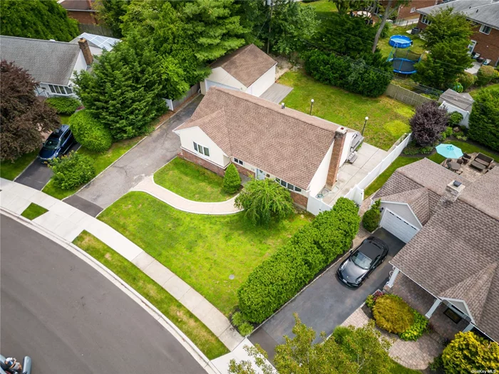 Welcome to this well-maintained ranch home located in the award-winning Syosset school district. This single-family features 3 bedrooms and 2 full baths, and a newly built deck, roofing, and siding. This home boasts an open layout living space and generously proportioned rooms throughout. Upon entering, you are welcomed by the bright and airy living & dining room,  the sliding doors in the living room is opening to a newly built deck and spacious backyard. The kitchen with casement windows features stone countertops, custom cabinets, and premium stainless steel appliances. The basement with bright windows, providing ample space for storage. In addition, there is a detached garage and a spacious driveway. The property is in a superb location and great neighborhood, a 5-minute drive to Syosset LIRR Station, proving direct access to Manhattan. It is a great choice for families looking for a peaceful lifestyle with an excellent educational environment.