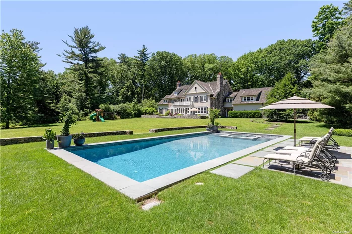 Presiding on over 3 pristine acres, this exquisite Colonial residence, constructed in 2003, offers exceptional privacy and serenity in the heart of the Village of Old Westbury. The exterior of the home is outfitted with a timeless cedar roof, stone and wood siding, copper gutters and a gravel driveway. This 6 bedroom, 6.5 bathroom home has a tasteful interior, containing spacious living areas surrounded by oversized windows and French Doors, flooding every inch with natural light. Custom millwork, curved archways and thick mouldings are present throughout the home, alongside rich hardwood flooring. Reset and recharge in the scenic outdoors. The property boasts a large stone entertaining terrace with a built-in grill area, a sprawling fenced-in green lawn space, a large in-ground pool and spa, a covered cabana/ outdoor lounge space and lively matured privacy landscaping.