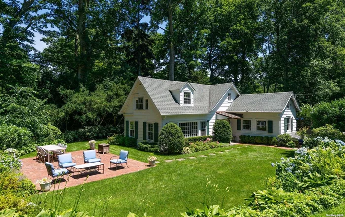 THIS IS ONE OF THOSE HOUSES THAT IMMEDIATELY GRABS YOUR ATTENTION. UPON ENTERING INTO THIS DELIGHTFULLY CHARMING CAPE YOU KNOW THIS IS HOME. BEAUTIFULLY SET BACK ON A LUSHLY LANDSCAPED ACRE ADORNED WITH HYDRANGEAS, PERENNIALS, AND MATURE TREES, THIS PROPERTY WILL ENCHANT YOU. INTERIOR DETAIL IS TASTEFUL AND INVITING. LARGE CATHEDRAL CEILING KITCHEN, GREAT ROOM WITH WOOD BURNING FIREPLACE, SPACIOUS AND BRIGHT DINING AREA AND FIRST FLOOR PRIMARY BEDROOM. CONVENIENTLY CLOSE TO LIRR AND VILLAGE OF LOCUST VALLEY EXTREMELY UNIQUE!