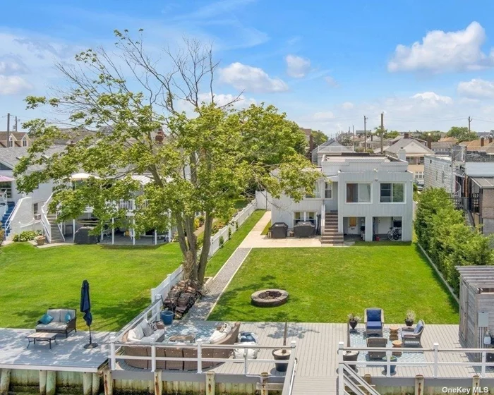 Vacation year round at this fabulous water front 2 family home. Enjoy stunning views of the sunset over Manhattan or launch your water toys from the 120&rsquo; new (2019) Trex dock PLUS quick and easy access to your own private backyard beach. Fenced in yard with patio, fire pit and outdoor shower. Lots of room to add more.  Enter primary unit through enclosed porch for year round use, large open concept living area with gas fireplace. Entertain from fun bar with seating.  Formal dining room, KIT, 3 bedrooms, Laundry. Walk in oversize shower in new spa-like bath. Hardwood floors throughout. First floor has private front entrance and features newly renovated Lvr, KIT, 1 bdrm and full bath. Parking in driveway for 3 cars plus street parking. 1 hour to NYC. Minutes to EAB resident beach, Beech Street eateries and unique shopping. Live your best life!