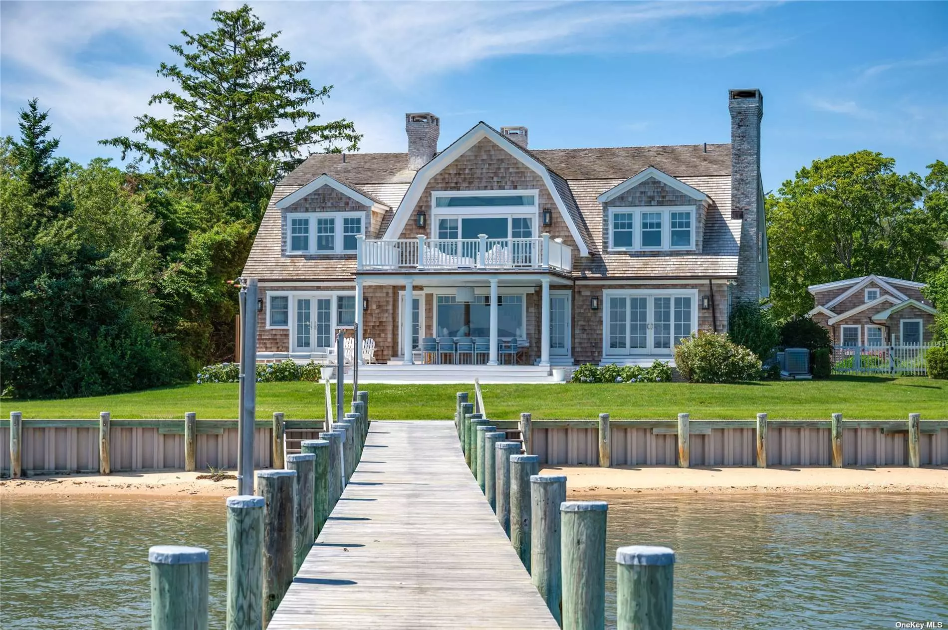 Enjoy all The Hamptons have to offer in this newly recreated waterfront home in the heart of West Neck Harbor! Complete with a boat and complimentary captain at the end of your private dock. Every detail was masterfully thought through by a leading design team. The floor plan offers a first-floor primary suite, four additional private guest bedrooms with two gracious common living spaces, a dining area and adjacent guest cottage. Every room was uniquely designed, each having endless water views of West Neck Harbor. Outdoor living includes a heated, salt water, gunite pool with spa, accompanied by a sauna and outdoor shower. From the patio, take a walk down the waterfront deck to watch the stunning sunset. Soak in every minute of summer at this waterfront retreat.