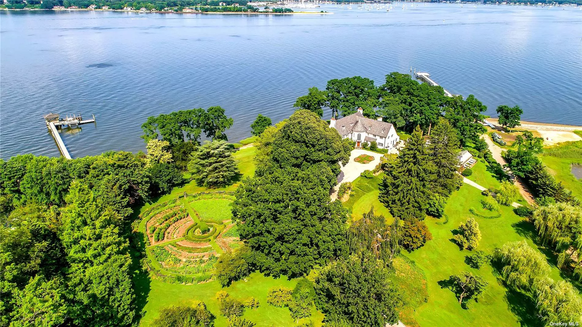 A spectacular waterfront property spanning 1.38 acres with 150 ft of water frontage and a spectacular sandy beach.