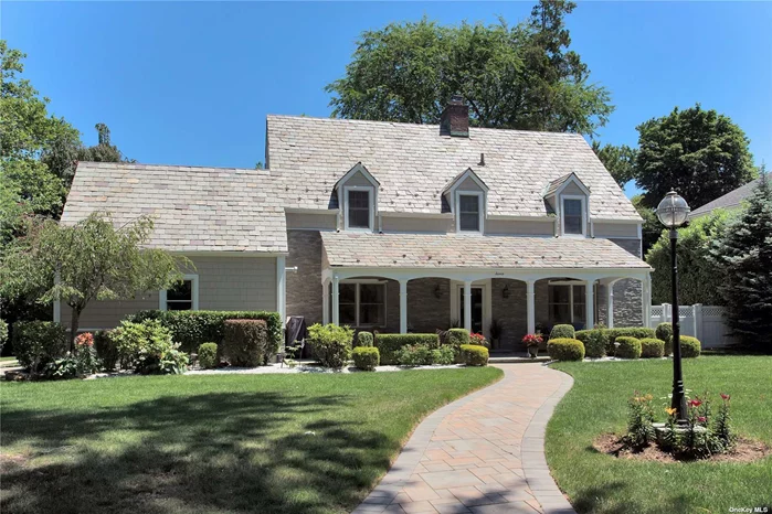 Gracious Center Hall Colonial, designed to perfection, has been created with the highest standards of modern style. Inviting front porch welcomes you to the elegant foyer and introduces the brilliantly appointed formal rooms with 9.5 ft ceilings, kitchen with custom cabinetry and granite countertops. Generously-sized living room with fireplace, private den/office, new powder room and ensuite bedroom complete the first level. The second level offers the a primary bedroom suite with a new full marble bath, two bedrooms, bonus room and newly renovated full bath. The lower level features a custom-built wine room and recreation area. The meticulously landscaped private backyard offers a great entertaining space with multiple patios. Located in the picturesque village of Flower Hill within close proximity to world-class shopping, fine dining, country clubs, golf courses, and major highways. With Port Washington LIRR parking rights.