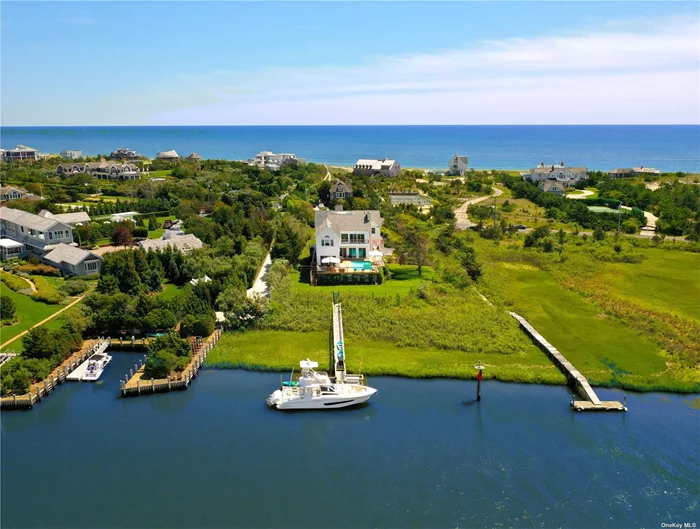Step into a realm of pure Resort Style living and waterfront splendor within this newly designed Hamptons Bayfront masterpiece. Behind the estate gate, graciously situated on a serene and meticulously maintained 1.4 acres, ensconced by vibrant gardens and exquisite specimen plantings, this distinguished Bayfront residence finds its place along the illustrious Dune Road. Here, where luxury living meets the tranquil embrace of nature, a sanctuary of waterfront opulence awaits your discovery. Perfectly situated alongside the shimmering bay, with the prestigious Quogue Field Club and golf course views as a backdrop, this unique Hamptons residence not only offers the utmost privacy but also presents a front-row seat to captivating sunsets while playing host to numerous summer activities. The poolside deck and lounge unveil a personal theater for nature&rsquo;s nightly spectacle-a symphony of colors gracefully dancing across the Hamptons skyline. Sitting bayside and center stage is the heated Gunite pool, wrapped in its spacious mahogany decking, inviting languid afternoons and tranquil evenings, making every moment a celebration of waterfront luxury. The North-South tennis court, is paired with a second floor south-facing deck overlooking the impeccably maintained red clay tennis court, is a testament to leisure and indulgence. Aspiring seafarers will delight in the brand-new fully equipped deepwater dock. Seamlessly moor your 42-foot yacht and embark on aquatic journeys to the wide-open waters of the Bay and Ocean whenever your heart desires. Ideal for entertaining all summer long, the fully equipped Chefs kitchen is a haven for culinary creation. Stainless steel appliances, bayfront panoramas, and a stylish yet functional design come together to elevate the ultimate culinary experience. Prepare gourmet delights while absorbing the tranquil bay scenery. Multiple living rooms thoughtfully designed for relaxation and entertainment create an abundance of gathering spaces ready to greet guests of all ages. Each corner exudes sophistication, inviting you to unwind, socialize, or simply bask in the bay&rsquo;s natural beauty. Ascend to the second floor to discover the oversized owner&rsquo;s suite-an intimate haven featuring a resort-style bathroom, western-facing balcony with gas fireplace, and an atmosphere of pure serenity. Another exclusive privilege to this wonderful bayfront offering includes your own private white sandy ocean beach just mere moments from your front doorstep. Enjoy, unwind and immerse yourself in the soothing rhythm of the rolling ocean waves and your pristine Ocean beach or choose the endless beauty and sounds of the open bay, the choice is yours. Car collectors will embrace the spacious and fully finished two-car garage, perfectly suited to accommodate your collection of luxury vehicles, and poised to effortlessly transport you to the charm of main street shopping and dining. Poised in anticipation of your imminent arrival, envision the delight of making this exceptional Hamptons Bayfront opportunity your home in the vibrant summer of 2024.