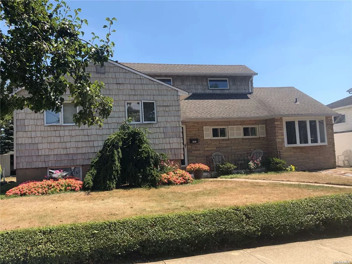 Lovely Extended Split Level Home in the Heart of Massapequa Park. Eat-in-Kitchen, Living Room, Large Formal Dining Room w/Sliding Door to Deck, Four Bedrooms. Den/Playroom, Bath. Basement. Oversized Property. Just Pack Your Bags and Move Right In.