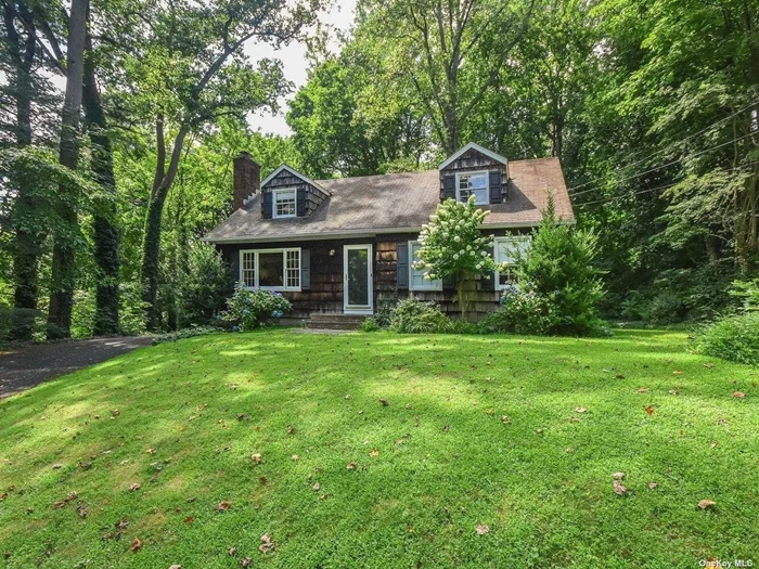 This charming Hilltop home, located on over-sized, lushly landscaped grounds sits on a very quiet lane.It offers an Entry Foyer,  Living Room with wood-burning fireplace, Eat-in-Kitchen, Formal Dining Room and a huge backyard, perfect for entertaining. Walk to village, schools, beaches. North Shore Schools, Beach Privileges.