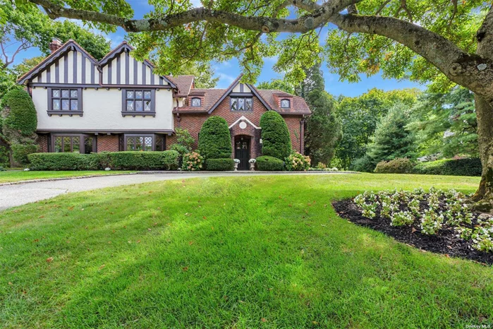 Stunning 5 bedroom English Tudor offers a beautiful welcoming spacious foyer, grand entertaining spaces including a 29x19 formal dining room with gas fireplace and a 32x25 great room with fireplace. A beautifully updated gourmet eat-in kitchen overlooks the park like property on .69 acres. Incredible architectural elements & stylish finishes throughout. A serene primary suite with fireplace & seasonal water views offers a gorgeous primary spa like bathroom plus 4 additional bedrooms & 4.5 baths. All on a quaint cul de sac in The Inc. Village of Plandome Manor. Recently stylish & chic updates blend old world charm with a sophisticated transitional flair. In the heart of Plandome Park with rights to Plandome Park Beach with additional dues for membership. A spacious bluestone patio for casual entertaining. Plandome Manor train parking with sticker/fee.