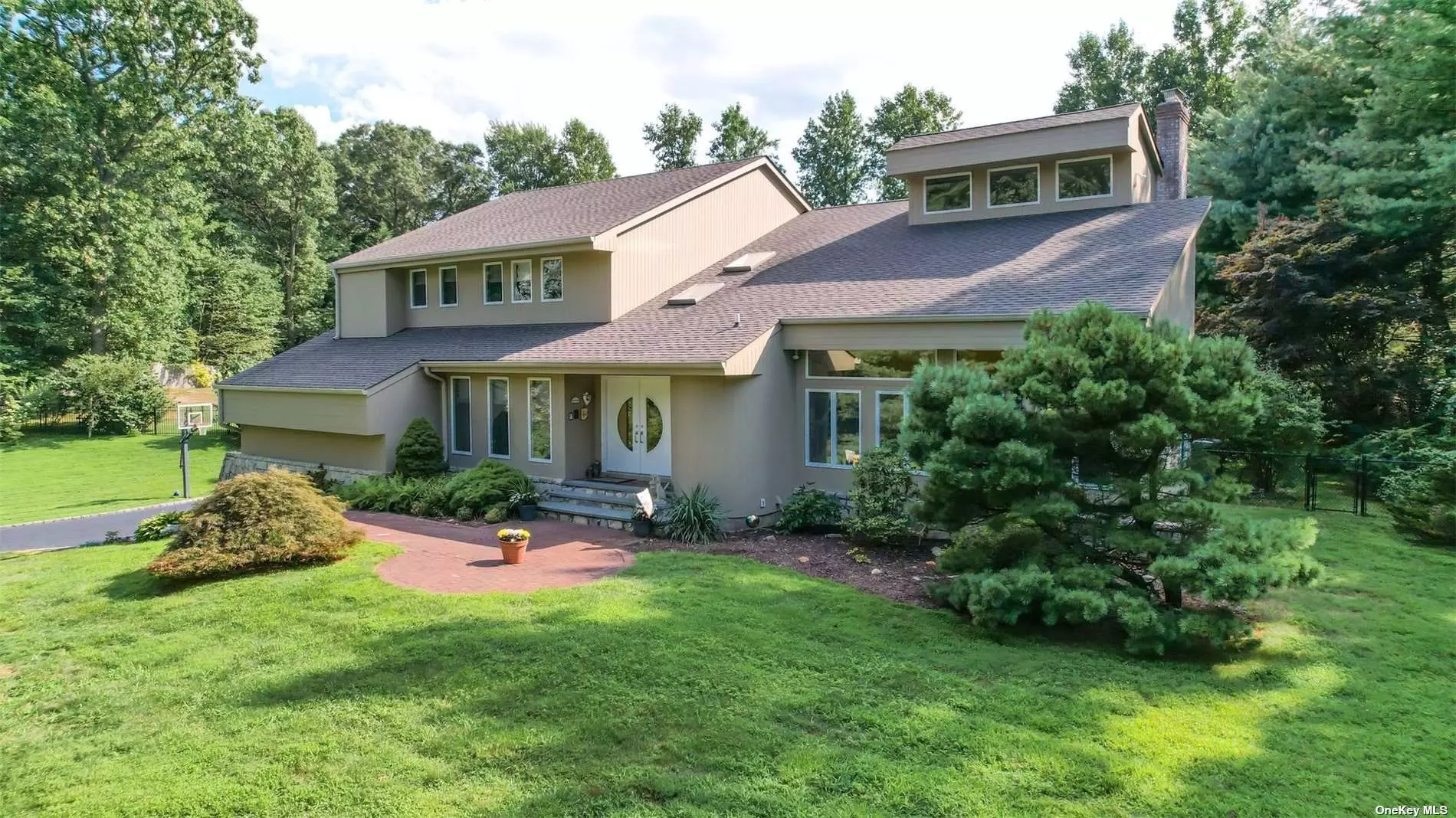 This outstanding, custom-built home is situated on two gorgeous acres with a heated inground pool, expansive backyard, decking, 3 car garage, all spacious rooms, fabulous glass entry staircase plus back staircase, and sunny solarium. The kitchen was recently updated and located within the Hamlet of Oyster Bay which is home to Sagamore Hill, the summer house of Theodore Rosevelt, the Waterfront Center, Marina, Parks, Planting Fields, a revitalized Village with upscale and casual dining, shopping, LIRR, beaches, and more. Convenient access to commuting to NYC, 35 miles down the road by train or car, all within the Oyster Bay-East Norwich Schools.