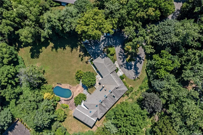 A Sands Point Contemporary, on over 2 Acres of sprawling, park-like property with beautiful privacy landscaping and a heated stone pool with a waterfall-feature. This residence has a surplus of natural light, 5 bedrooms, 4.5 bathrooms, a large walk-out finished basement and a 2 car attached garage. Additional details include a bluestone outdoor patio, floor-to-ceiling wood-burning fireplace, spacious rooms, a Teak deck and tall ceilings. Village amenities include a private community golf course, beach rights and direct LIRR express ride to the heart of Manhattan.