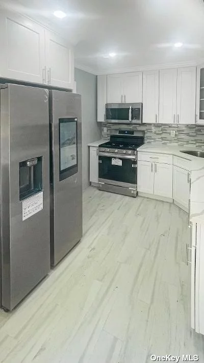 THIS PHENOMENAL FULLY RENOVATED- TOP TO BOTTOM- CAPE BOASTS 4 BEDROOMS, 2 FULL BATHS, FULL FINISHED BASEMENT W/ FULL BATH, CENTRAL AIR, GAS HEATING, HARDWOOD FLOORS THROUGH OUT, NEW ROOF, SMART REFRIGERATOR, SMART 4K TV,  RING CAMERA, HUGE 130 X 90 LOT, AND RENOVATED DETACHED GARAGE! TOO MUCH TO LIST! WILL NOT LAST! DREAMBOAT EDITION! A MUST SEE! WILL NOT LAST!