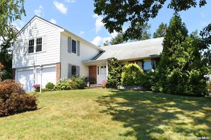 This newly painted colonial is light & bright with a vaulted living room, dining room, large kitchen, family room with fireplace, powder room, laundry room, and entrance to 2-car garage. Upstairs offers four bedrooms (incl. primary ensuite) along with hallway bath. The basement provides additional space for get-togethers or playtime. New carpet in LR, family room, all bedrooms, and basement. Central air, gas heating, 150amp electric, many newly replaced windows, and in-ground sprinkler system. Backyard has mature plantings providing privacy.