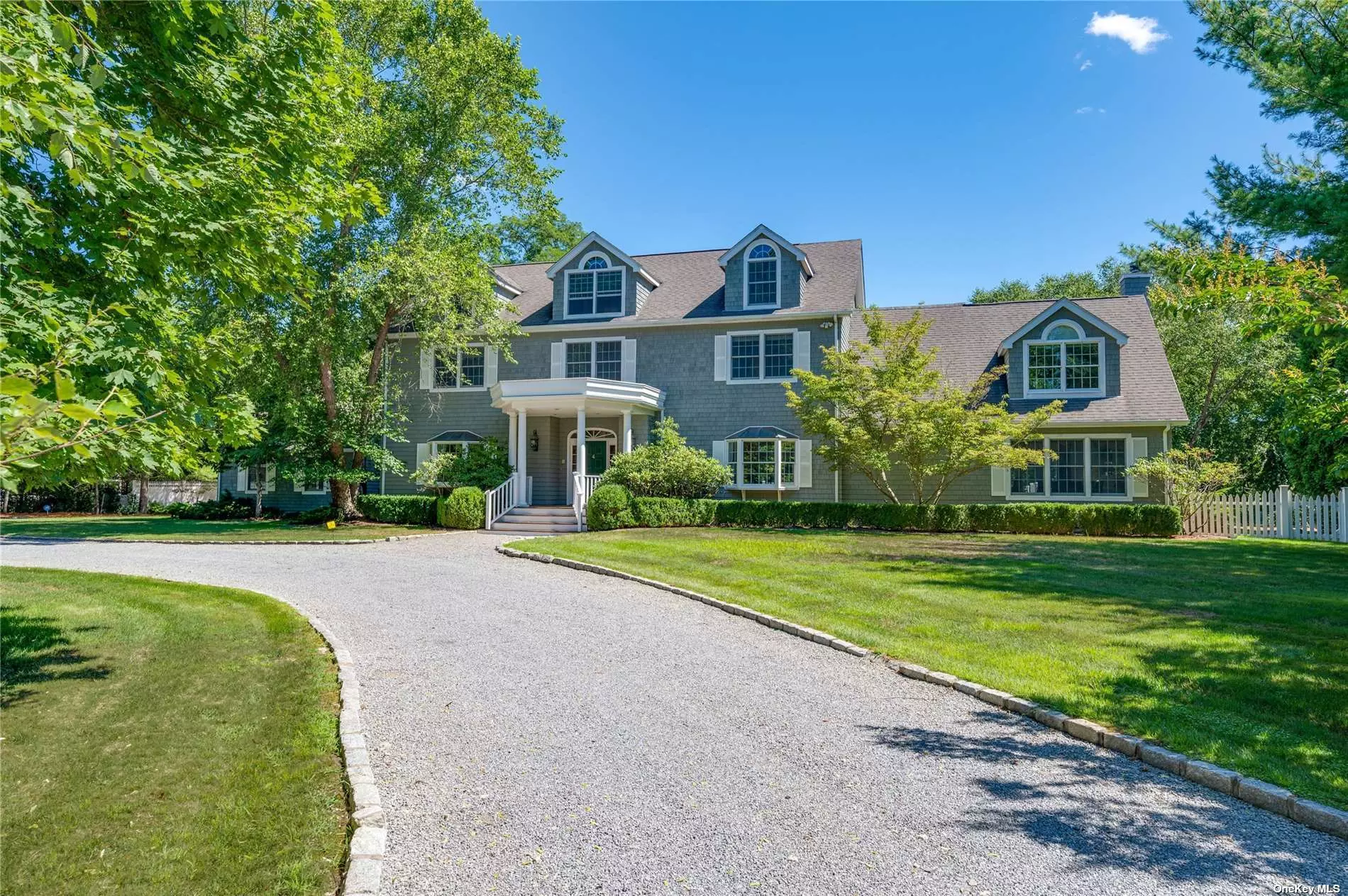 Welcome to 4 Hidden Pond Lane, this impressive home is set back from the main road and located on a private street surrounded by almost two acres of beautifully, pristine landscaped grounds. &lt;br&gt;&lt;br&gt; As you arrive through a pillared entrance, the circular pebble stone driveway leads you to the attached and oversized two car garage. You will be charmed by the lovely grey cedar shake fa?ade and white picket fence that lines the back property of this unique home. &lt;br&gt;&lt;br&gt; On the main floor, the inviting living room has a cozy gas fireplace that is flanked by two sets of 3 large glass paned shaker style doors, that lead you to the expansive outdoor deck with a gas grill overlooking the tasteful gunite swimming pool, hot tub and slate stone patio. &lt;br&gt;&lt;br&gt; This truly oversized and special home offers you everything you will need. With 5 generously sized bedrooms, 5 full baths and 2 half baths, a formal dining room, a media room, laundry room, cedar sauna, a home office, a den, an extra-large chef&rsquo;s kitchen fitted with maple cabinetry, a breakfast island, granite counter tops, Viking stainless steel appliances to include a microwave, wine fridge and ice maker and can also hold an addition dining table to easily accommodate 8. &lt;br&gt;&lt;br&gt; Conveniently located on the first-floor, just off the living-room is a primary bedroom surrounded by large beautiful 8 over 8 windows and a 15 ft ceiling. This lovely bedroom includes an en-suite bath with a glorious steam shower, a vanity with double sinks and a Kohler deep soaking spa tub. &lt;br&gt;&lt;br&gt; Just one flight up on the second floor, you will find another primary and/or master sized bedroom with an en-suite bath that too includes a shower and deep soaking tub, plus three additional rooms that can be used as bedrooms, guestrooms, a home office, den or study. &lt;br&gt;&lt;br&gt; Up one more flight to the third floor you will find even more bonus space, an amazing mahogany paneled room that is perfect for another bedroom or guestroom or any type of special space you may want to create. &lt;br&gt;&lt;br&gt; Built in 2003, this magical and unique property is much more than you can imagine, and a must see to truly get the feel of this rare and notable home. With over 6700 square ft. of living space, this tremendous home is perfect for a summertime retreat at the beach with family and friends and a grand year- round home. Other notable features include central air conditioning with 3 heat and a/c zones, an alarm system, outdoor irrigation along with closets and storage galore. Move right in or bring your contractor to create your own special interior. &lt;br&gt;&lt;br&gt; Close to Village shopping, caf?s, restaurants and everything you will need. Easy to show - please contact me for a private viewing or make an appointment for our next weekend open house.