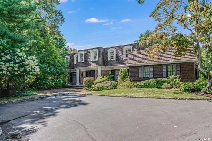 This traditional country colonial sits on a 2-acre private cul-de-sac lot in Muttontown, Oyster Bay School District. The mahogany front doors are among several features in this home, including a large entry foyer, aformal dining room with bay window, family room with fireplace, and an eat-in kitchen with a breakfast area, as well as sliding glass doors to your large mahogany outdoor deck with pool views. This gourmet kitchen comes complete with commercial S/S appliances, a deep farmhouse sink, a wood-burning fireplace, a gorgeous range hood w/country tile, pot filler faucet, there are two more bedrooms on the first floor, as well as a half bath and a laundry room. On the second floor, you&rsquo;ll find four bedrooms, including a large primary bedroom with a sitting area, fireplace, and walls of closet space. With a partially finished basement, you can enjoy a recreation room, plenty of storage, and a full bath. Enjoy the natural world in your zen backyard space where there is open air & peace
