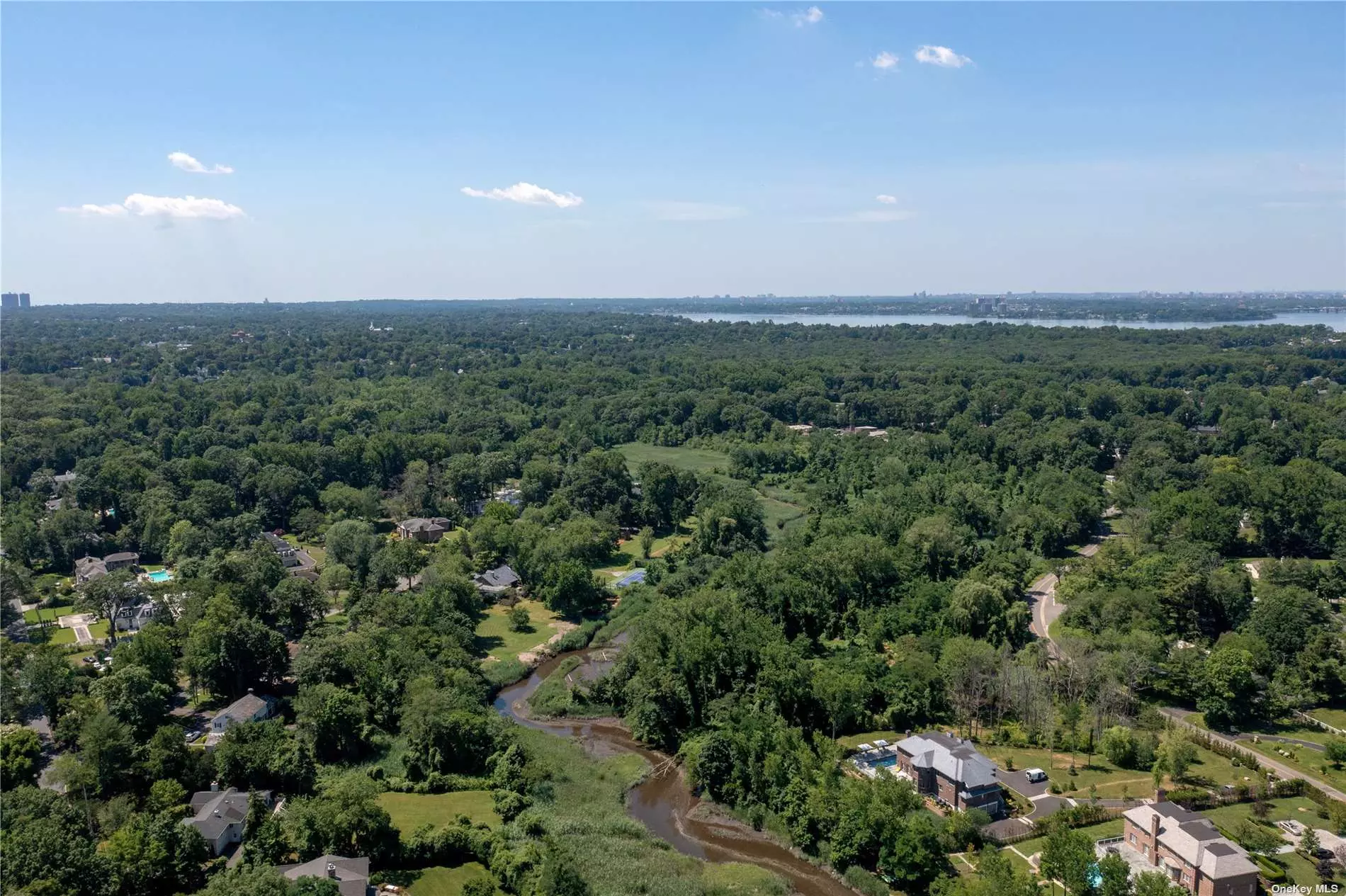 Custom build your dream home on this beautiful 2.06+ Acre lot in the heart of the esteemed Village of Kings Point. Flat, private property with scenic views of Mitchell Creek.