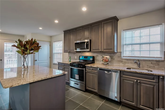 This Beautiful Unit Features An Open Floor Plan With A Granite Kitchen, Stainless Steel Appliances, Central Air, And A Balcony. Private garage that enters into your unit and a washer/dryer in the unit. Conveniently Located Close To Town and Transportation As Well As Shopping, Dining, Beaches, And Golf.