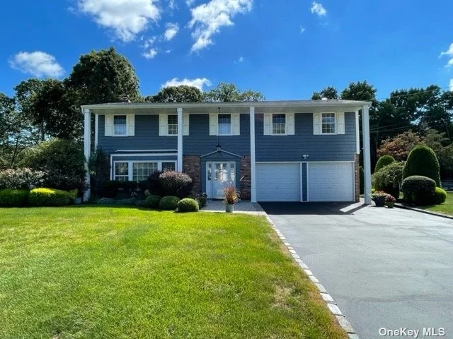 Sprawling Colonial Home just minutes from Smith Haven Mall & 10 mins from LIRR!! This is the perfect private sanctuary w/ no rear neighbors. Features include an open flow living space with custom arches between the living and dining spaces. The 4 season sunroom allows you to enjoy each season from the comfort of your home. Nest thermostat and CAC throughout. The heart of the home showcases an eat in kitchen w/ GE SS appliances, a double wall convection oven w/ self cleaning features, dish washer, microwave and french door style refrigerator. 3 Spacious bedrooms and master suite with walk in closet and private en suite bathroom. The backyard sanctuary includes an in ground heated pool, brick pavers and patio and private hot tub. Hot & cold water faucets in garage and a 90 min fire door to garage. Generator w/ hookup to electric panel, slop sink in the basement in addition to a brand new dehumidifier. 200 amp system, whole house water filter.