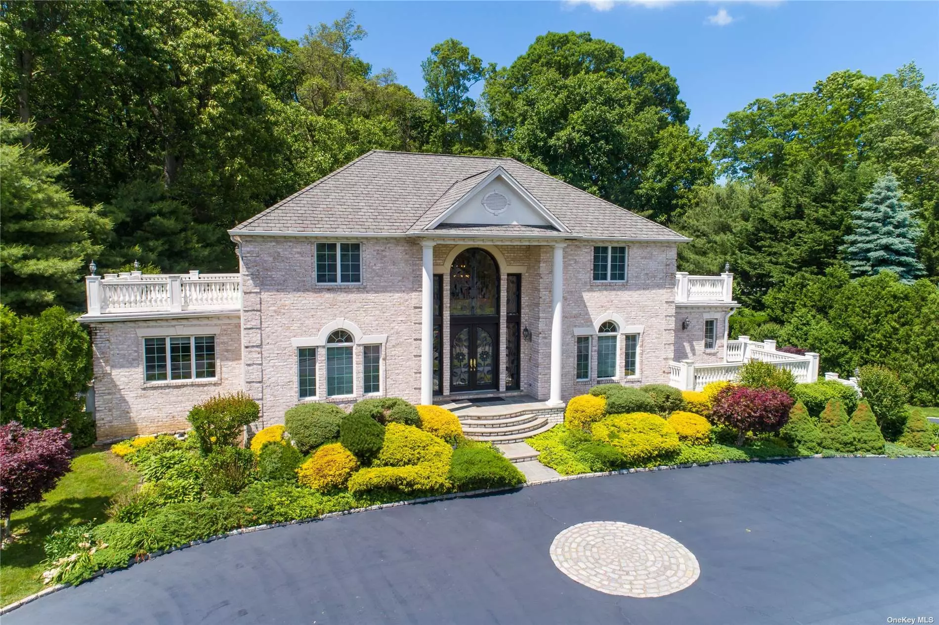 Location is Everything! Welcome To Old Westbury&rsquo;s Timeless & Classic Brick Colonial Perched High & Set Deep In A Private Cul-De-Sac. Custom Built Home On 2 Acres That Boasts An Appreciation For Nature w/Large Walk-Out Terraces/Patios In Almost Every Room! Panoramic Views Upstairs & Downstairs. The Grand 2-Story Foyer Leads Into A Living Room That Showcases 20 Ft. Ceilings w/A Wall of Windows Overlooking The Bucolic Backyard. The Open Floor Plan Offer Generous Sun-lit Rooms, Including A Home Office, Which Could Be Possible 5th Bedroom, Chef&rsquo;s Kitchen Complete w/Gas Cooking & Viking Appliances. 2 Primary En-Suites (One On The Main Level) Custom Built Walk In Closets In Every Bedroom. The Fully Finished Lower Level Features 14Ft Ceilings, A Huge Playroom & Tuscan Style Wine Cellar. Plus Complete Kitchen, Climate Controlled Storage Rooms, 3 Car Garage, 5 Zone Heating/AC . VERY LOW TAXES $30, 655.57 including Village Tax. Only 22 Miles From NYC & Easy Access To All Major HIghways.