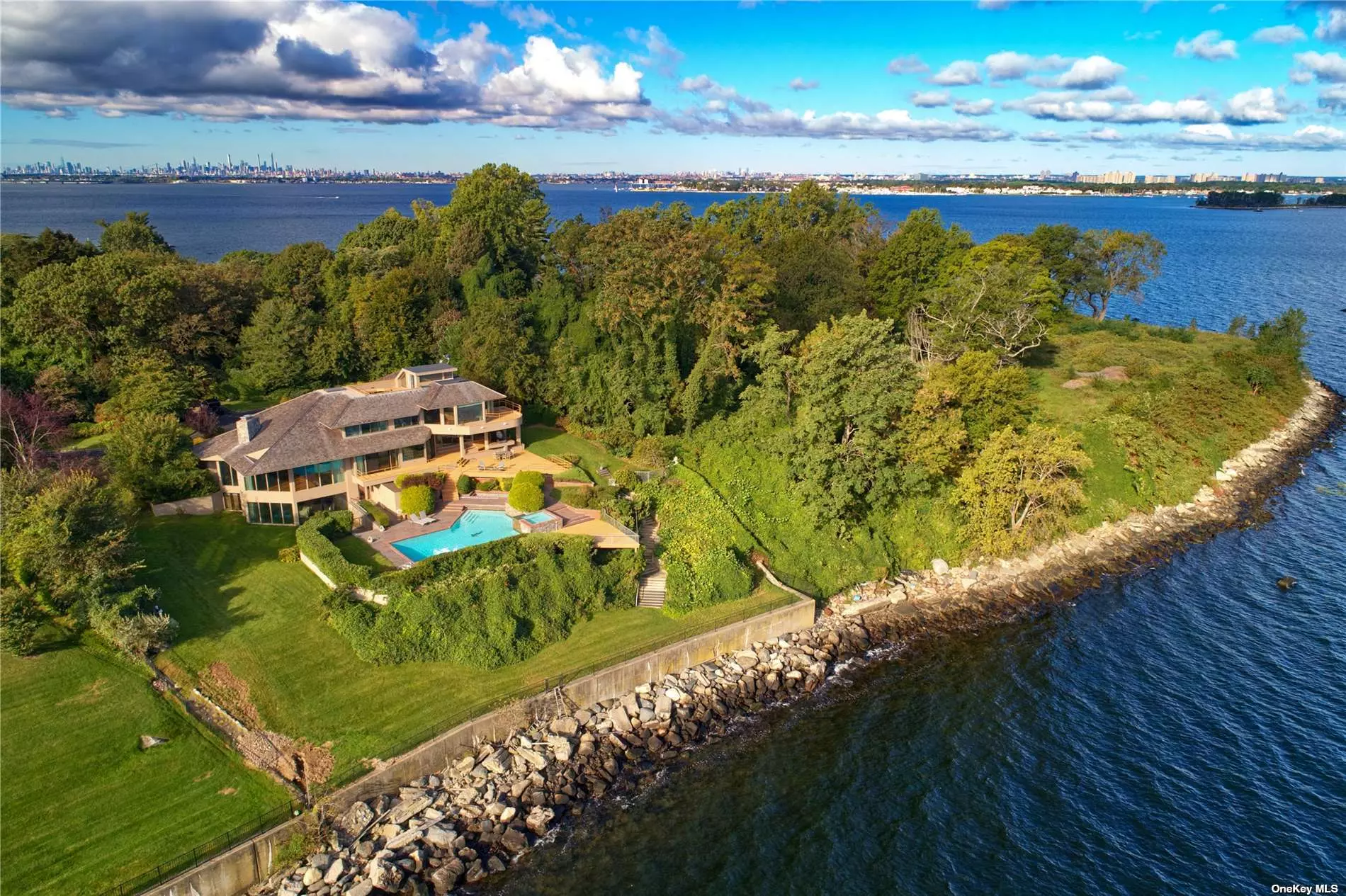 This Architectural Contemporary Masterpiece in the Prestigious Enclave of Kings Point is Set on Over 1 Acre of Serene Waterfront Property on One of the Most Famous and Sought After Addresses on the Gold Coast of Long Island, Gatsby Lane. Built for Entertainment, the Home Features Exquisite and Expansive Waterfront Views With Floor to Ceiling Windows, Multiple Balconies, In Ground Heated Pool, Game Room, Gym and Many Gathering Areas Throughout the Home and Property. The Primary Bedroom Has Separate Sleeping and Dressing/Sitting Area With Two Full Baths As Well As a Private Balcony and Access to a Private Roof Top Deck Under the Stars. Relax , or Entertain By Poolside While Capturing the Spectacular and Expansive Breathtaking Water Views of the Long Island Sound.