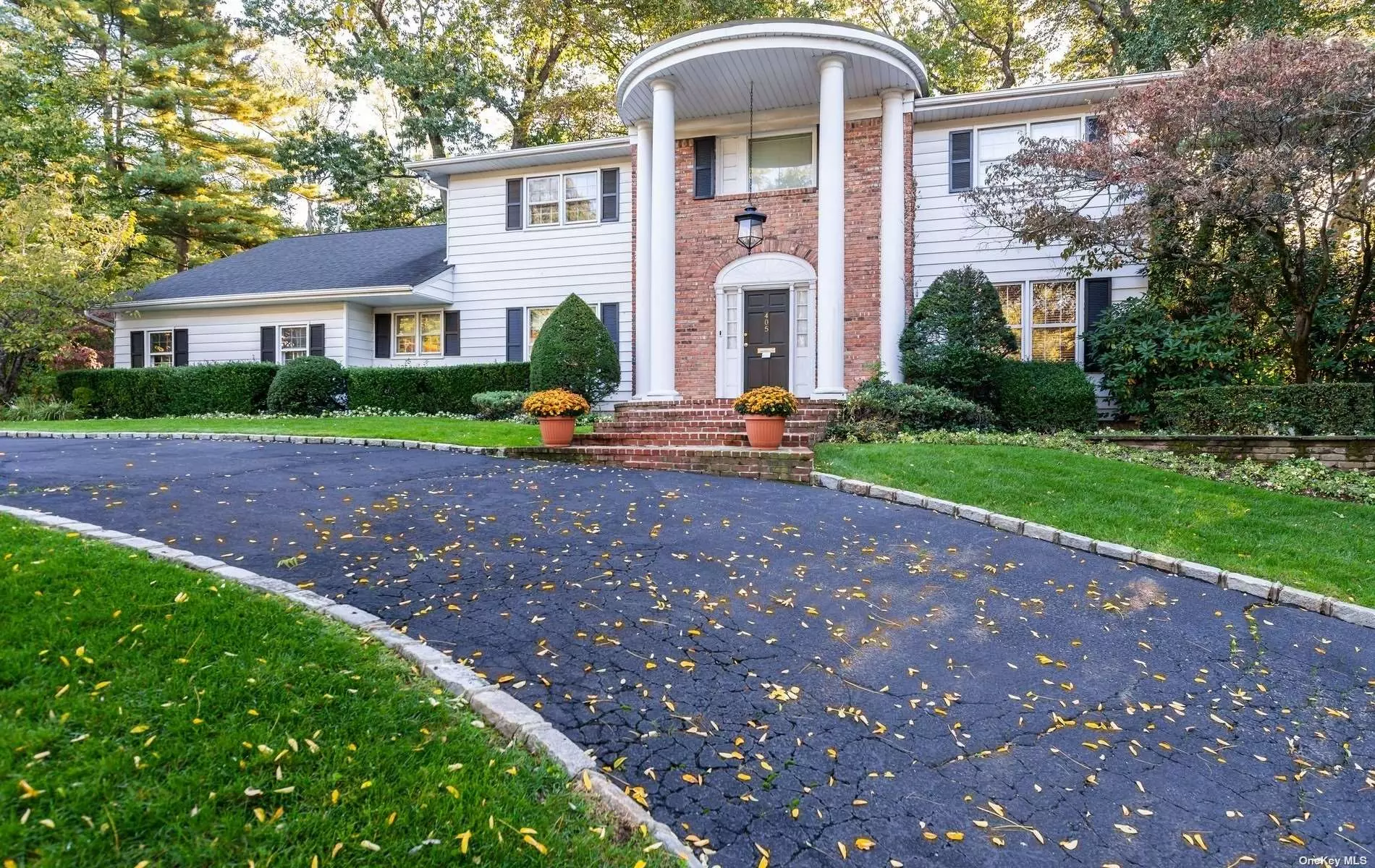 This desirable Country Estates Centerhall Colonial was the builders model and features oversized rooms set on.57 acre.  This elegant 5 bedroom, 3.5 bath home backs wooded area and sides quiet cul de sac. This renovated home boasts whole house generator, radiant heated floors in baths, guest wing/office with bath, large kitchen with center island, formal dining room with beautiful hardwood floors, stunning living room with wood burning fireplace and large den. Near sought after EH Pool and Park. Roslyn SD.