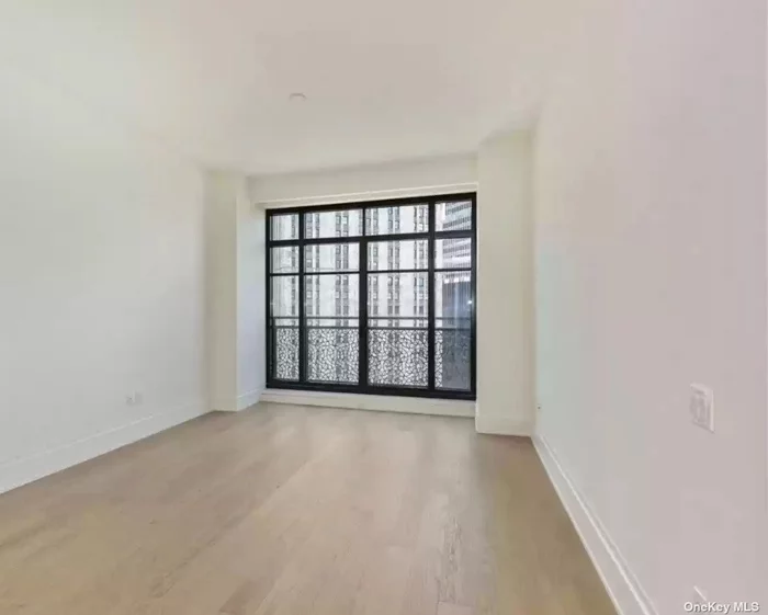 A large one bedroom, with one-and-a-half bath residence offers sweeping views over historic City Hall Park. At 915 SF with over 10&rsquo; ceilings, this residence features wide plank Italian oak flooring, and oversized casement windows accented with Juliet balconies. The open kitchen offers a cantilevered island featuring custom cabinetry and shelving with an overhang for seating in a choice of either walnut or white lacquer.