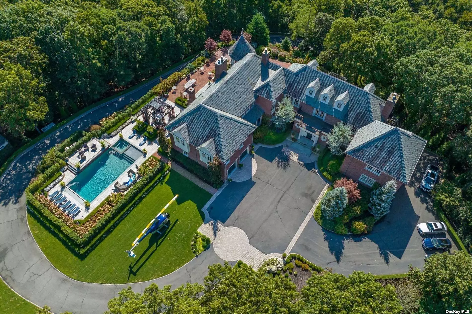 This Gated Majestic Brick Manor, features 6-bedroom, 6-bath, 3-powder rooms and sits at one of the highest points on Long Island surrounded by lush parkland and English gardens for the ultimate in serenity and privacy. This one-of-a-kind property has its own, FAA recognized, helipad which allows you the luxury to fly over traffic to NYC or the Hamptons with ease. This Estates sophisticated elegance depicts exquisite attention to every detail featured, from custom mill work, exotic quarter sawn wood floors, imported marble with everything covered from its energy efficient geo-thermal heating & cooling, radiant heat throughout, gourmet EIK, palatial principles-suite, expansive additional living quarters, 4 fireplaces, ornamental iron details with security system, heated driveway and much more. This home is truly an entertainer&rsquo;s paradise with in-ground heated pool & spa w/ salt system and waterfalls, starlit home theater, indoor squash & basketball court, gym, game room, and workshop .