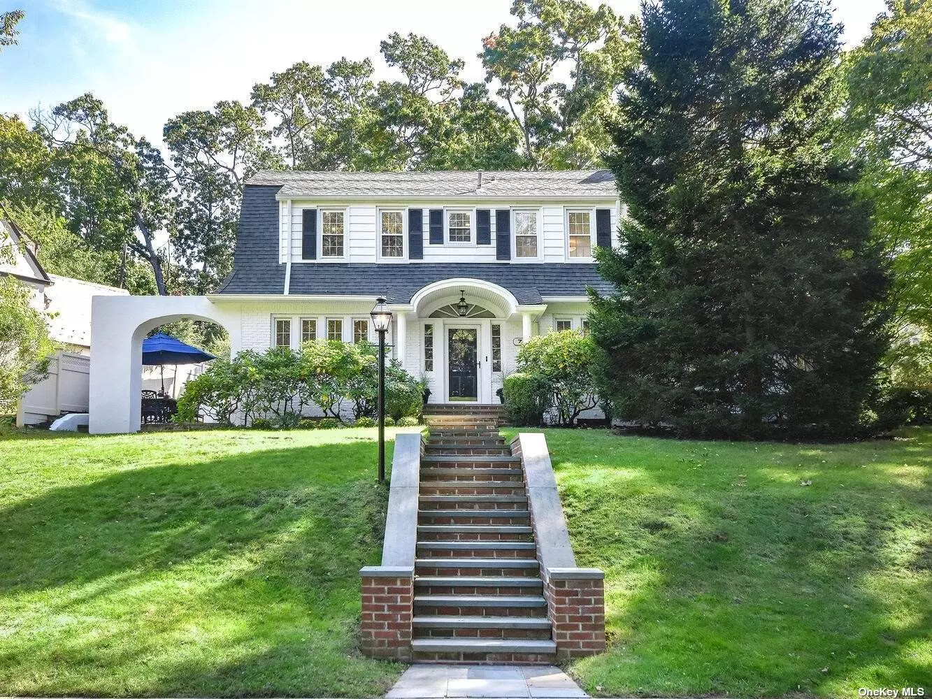 BEACON HILL BEAUTY! This gracious true Center Hall Colonial on well over a quarter acre is a must see! Living room with fireplace, formal dining room, large Great Room with fireplace, 2 sets of French doors, walls of windows, and 4 skylights. The large eat-in kitchen with center island and abundant cabinet space, with access to tranquil patio. Powder room. Back staircase to second floor. The king-sized primary bedroom boasts a renovated bath. Three additional bedrooms and hall bath plus laundry. Full basement. Detached 2 car garage, gas heat, and more!