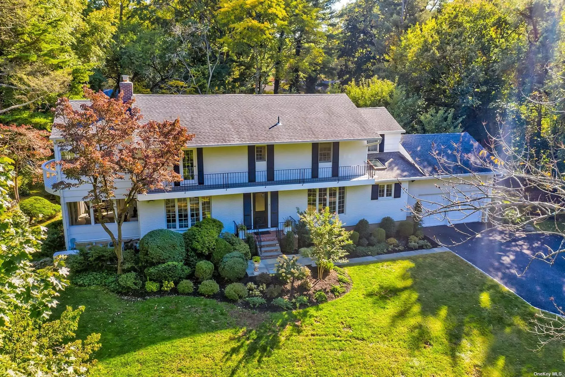 Sundrenched Classic Center Hall Colonial in the sought after Harbor Acres section of Sands Point. Perfectly positioned atop a professionally landscaped 1.1 acre property with mature plantings & nestled at the end of a lovely quiet cul-de-sac. The open staircase in the entry foyer welcomes you into this special home. The gracious light-filled updated living spaces incl: Living room with gas fireplace. Formal dining. Screened in porch. Eat-In-Kitchen with sliding doors to deck & yard. Amazing den with vaulted beamed ceilings. Home office. Full bathroom with laundry complete the first floor. Stunning primary ensuite with cathedral ceilings, multiple closets, wb fireplace & sitting room with balcony. The primary bath has a freestanding tub, custom shower, marble counters & tiling & double sinks. 2nd ensuite bedroom connects to den. 2 addl bedrooms & full bath. Basement with recreation, 2nd laundry, storage, OSE. CAC, 2 car att garage, generator & more! Assoc Tennis & Beach with fees.