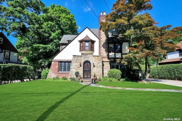 Brick tudor with high ceilings, large Anderson windows and light filled rooms. Expansive first floor has 2 dens, one of which can be used as a first floor bedroom or office. Oversized living room with gas fireplace. Large eat in kitchen with 2 sinks open to gracious sized dining room perfect for entertaining. Second floor has 3 large bedrooms and 2 bath and there is a finished attic. Walk to all, close to town, shopping and parks. Full finished basement!