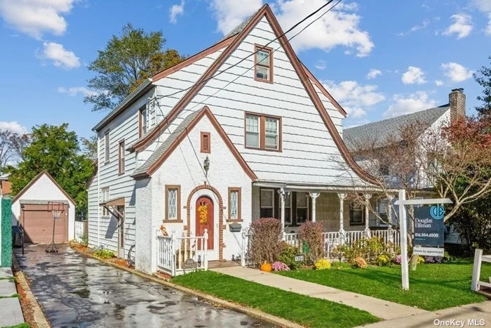 Storybook Colonial on a great block, with charming front porch, Hardwood floors, new roof, EIK plus separate dining room, sliders to rear deck and large fenced yard, side den off living room, full unfinished basement.