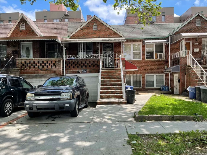 This two-family property has two bedrooms, a living room, and a full bathroom on the second floor. The first floor has a one-bedroom apartment with an eat-in kitchen, a living room, a full bathroom, access to the backyard, and an attached garage.